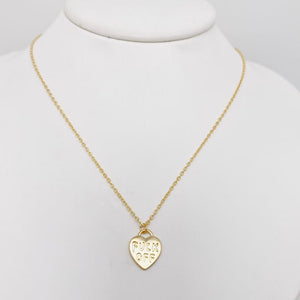 Heart-shaped pendant in gold metal engraved with “FUCK OFF” on a matching link style chain