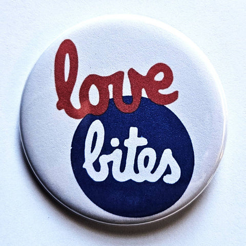 1.25" round button of Buzzcocks' album art for "Love Bites" in red, blue,  and white script on white background