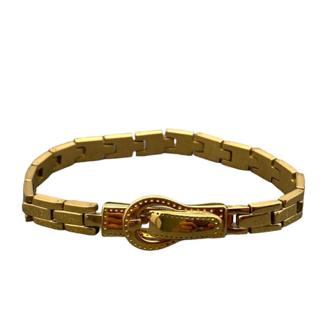 An 18k gold plated stainless steel watchband-style bracelet with a magnetic buckle closure. Seen closed