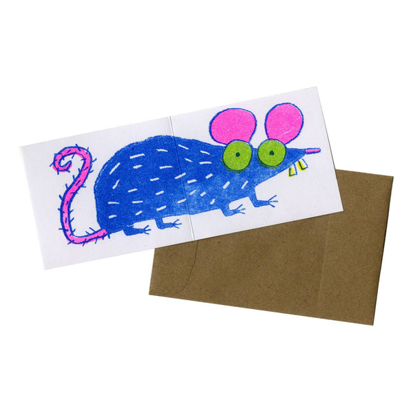 heavyweight card stock note card with a neon pink, green, and blue risograph image of a cartoony rat that wraps around both exterior sides of card. Shown flat with brown kraft paper envelope