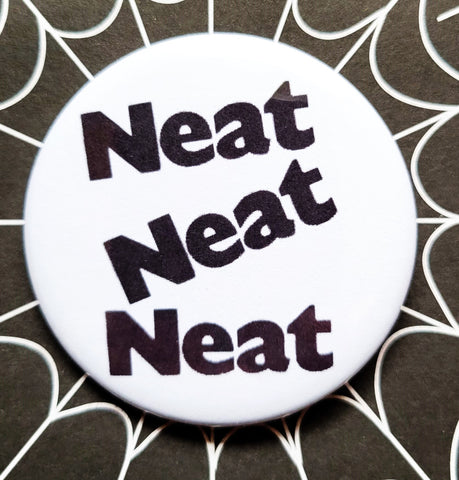 1.25” round pinback “Neat Neat Neat” font from The Damned 7”