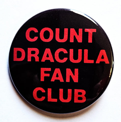 1.25” round pinback button with black background and message “COUNT DRACULA FAN CLUB” in red font