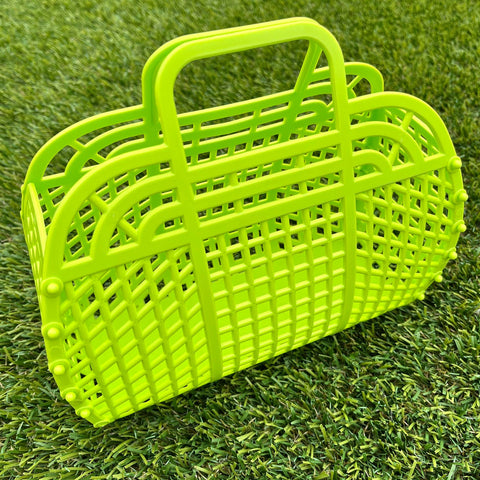 A small lime green rectangular handbag made of plastic with a lattice pattern
