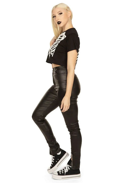 Person wearing a black cropped t-shirt with a skeleton ribs design. Shown from the side