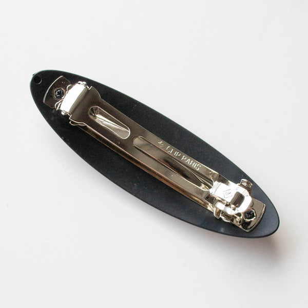 black acrylic oval shaped barrette. Shown from back