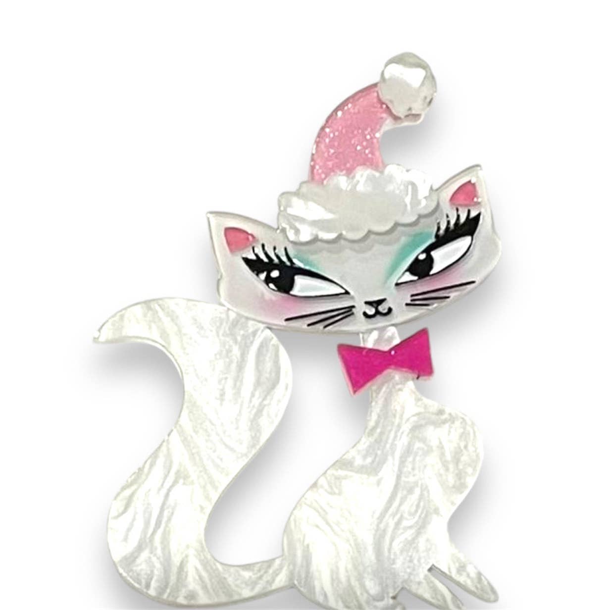 white pearly resin cat with a glittery light pink Santa hat and pink bow tie layered resin brooch