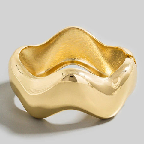 wavy shaped gold metal bangle with hinge closure