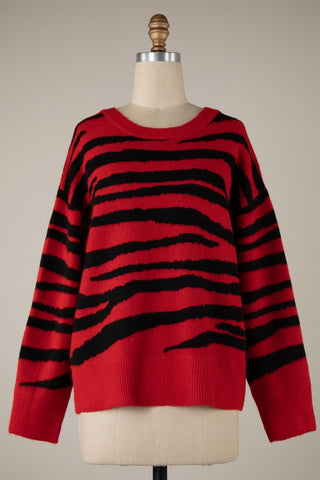 crew neck pullover sweater with drop shoulders in a black and bright red knit-in zebra print. Shown from the front