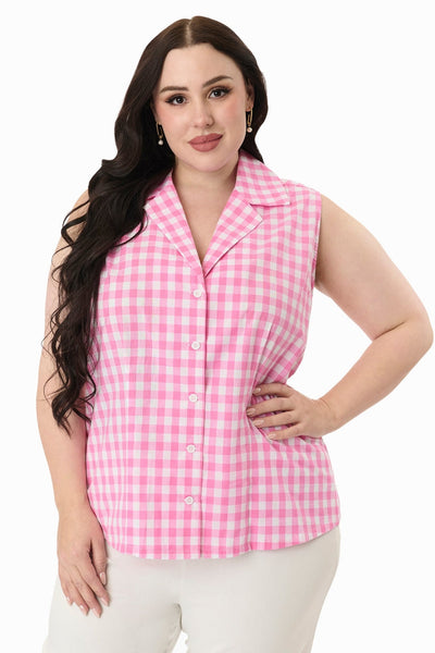 Plus size model wearing sleeveless cotton button-up blouse in white and pink gingham pattern with pointed notched collar. Shown untucked from front