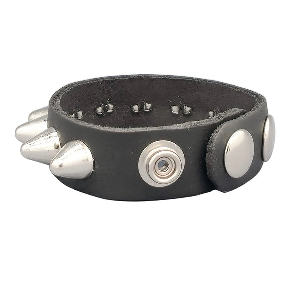 Single row silver metal English cone studded 3/4” wide black leather bracelet with double snap closure. Shown from snap closure side