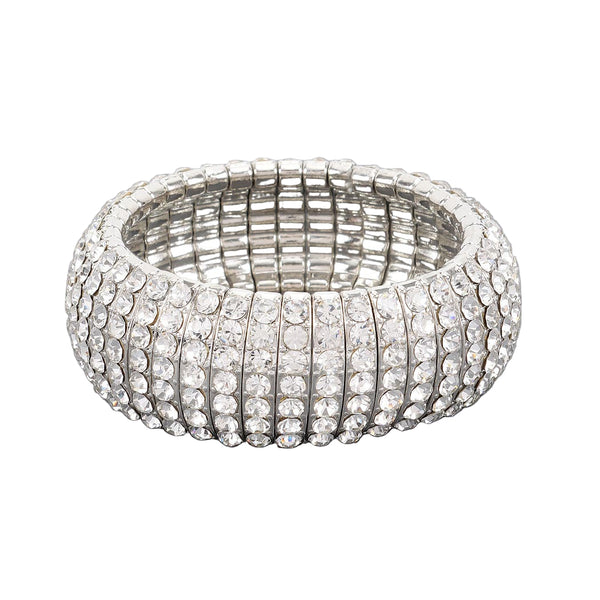 stretch silver metal segmented bangle with eight rows of clear rhinestone style jewels. Shown flat