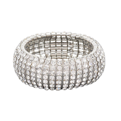 stretch silver metal segmented bangle with eight rows of clear rhinestone style jewels. Shown flat
