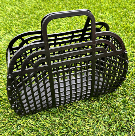 A small black rectangular handbag made of plastic with a lattice pattern