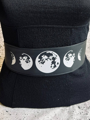 black faux leather wide tie style belt with black ribbon ties and white moon phase image shown on dress form