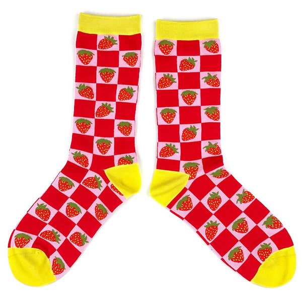 Crew socks with a knit-in pattern of strawberries on a pink and red checkered background with bright yellow cuffs, toes, and heels. Shown flat to display both sides of sock 