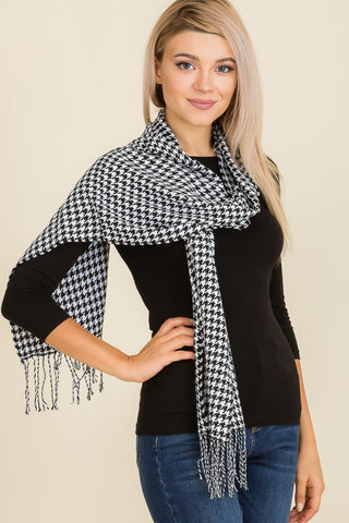 model wearing fringed winter scarf in a black and white houndstooth pattern