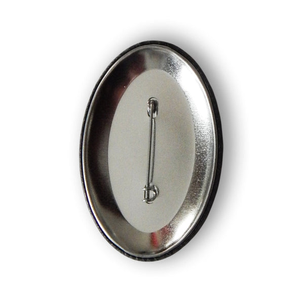 oval shaped metal 2.75" pinback button of silver metallic skull with red and yellow eyes and "666" written across its forehead on black background. Shown from back