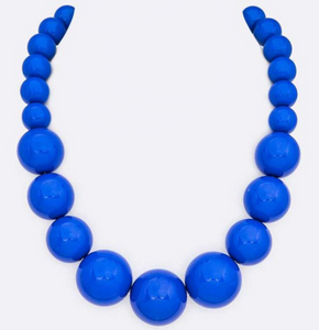 18” long strand of graduating size shiny royal blue round resin beads