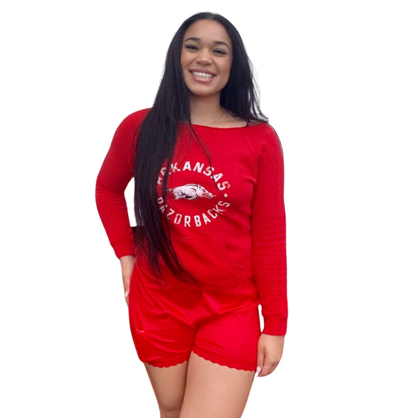 Red nylon high waisted slip shorts with scalloped red lace trim at the legs and elasticized pocket at right leg. Shown worn by model