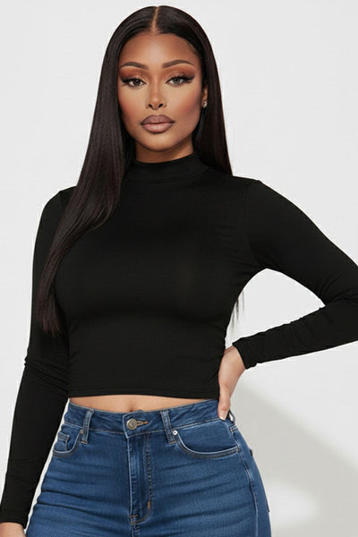 model wearing black long sleeve mock neck crop top. Shown from front