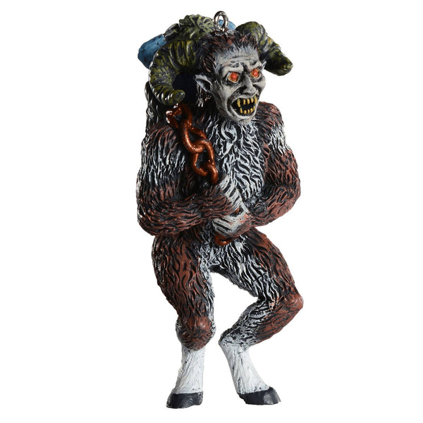 resin painted ornament in the shape of Krampus carrying a child in a sack