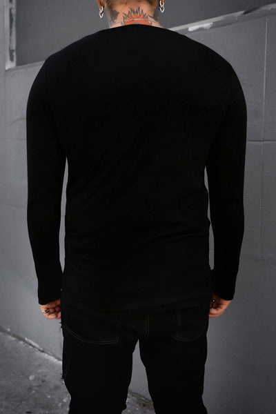 model wearing black long sleeve crew neck shirt with thumb holes. Shown from back