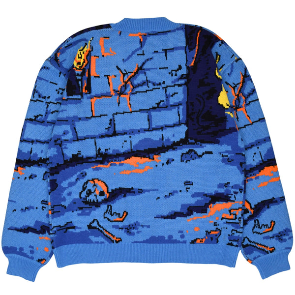relaxed fit cardigan with jacquard knit pattern of 8-bit style pixelated dungeon design with bones, brick wall, and orange ooze on ground. Sweater has patch pockets, v-neckline, tortoiseshell buttons, and ribbed collar and cuffs. Shown from back