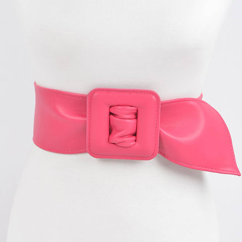 Bright pink matte finish faux leather belt with a large square self buckle on dress form on a white background