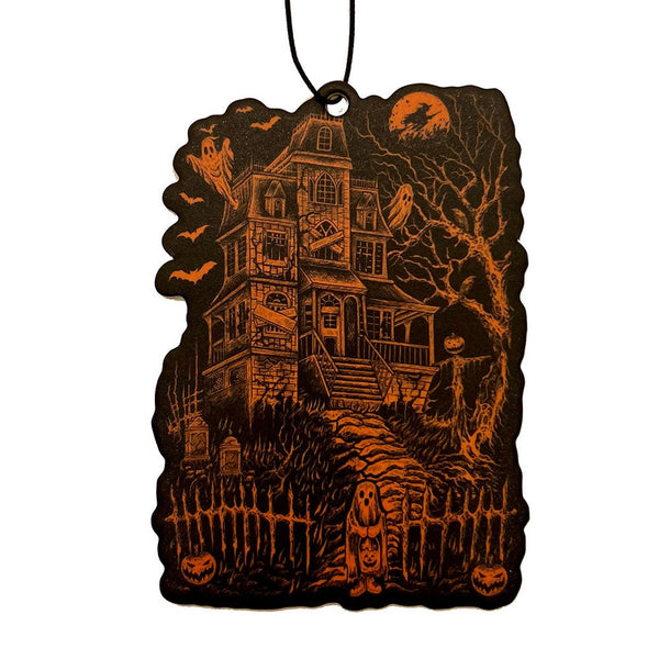 Halloween-themed air freshener with a haunted house design in orange on a black background