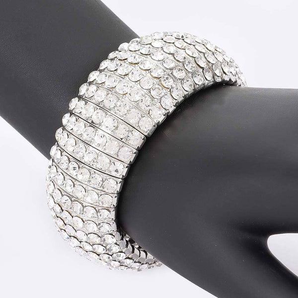 stretch silver metal segmented bangle with eight rows of clear rhinestone style jewels. Shown on mannequin arm