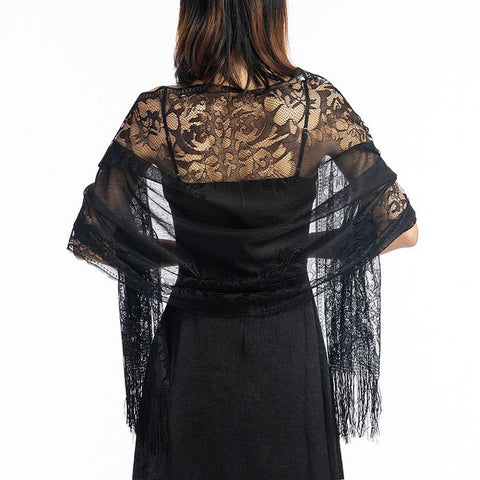 Black lace shawl draped over a person on a white background