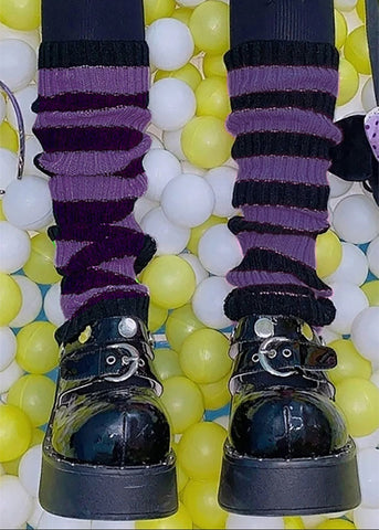purplee and black ribbed striped leg warmers shown worn by model with ripped tights and black patent shoes