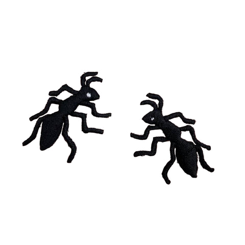 set of two mirrored black ant-shaped patches