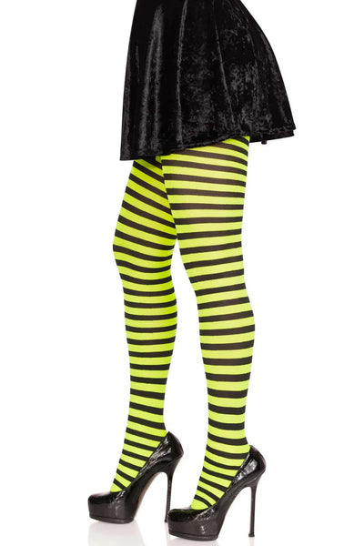side view of model wearing black and green striped tights on a white background