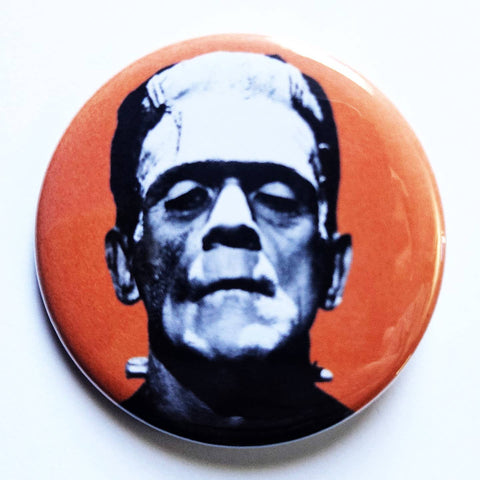 1.25" round pinaback button with black and white photograph of Boris Karloff starring as Frankenstein on a bright orange background