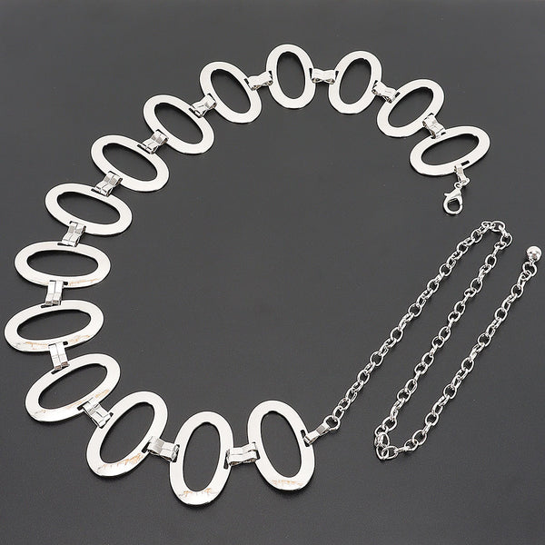 A silver metal chain belt with large flat oval links and a dangling chain extender, shown flat