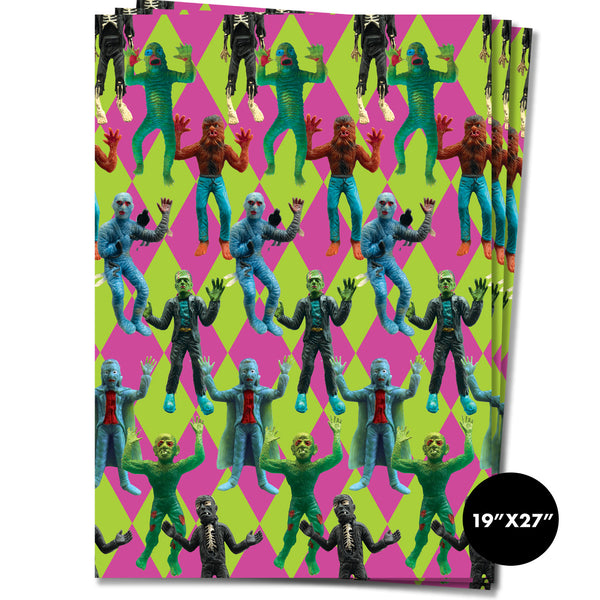 Rectangular wrapping paper sheets with neon pink and green diamond pattern and photorealistic rubber monster toys in foreground