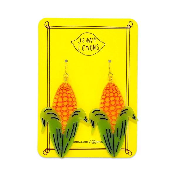 cellulose acetate dangle earrings in the shape of yellow ears of corn with half-shucked green husks and black painted detail. Shown on backing card