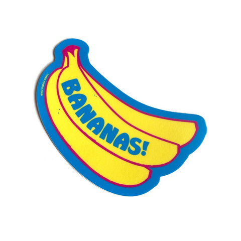 matte finish die-cut vinyl sticker of bright yellow illustration of bunch of bananas on blue background with pink outline and message "BANANAS!" in matching blue writing running down side of banana