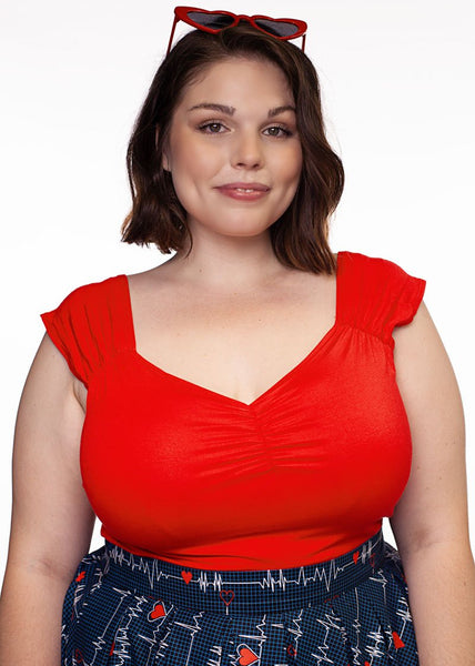 fitted bright red top in soft brushed fiber stretch knit cap sleeves sweetheart neckline, shown on plus size model wearing it tucked into high waist skirt