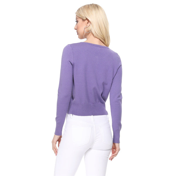 Cropped light purple crew neck cardigan with long sleeves and purple pearlized plastic buttons. Shown from the back