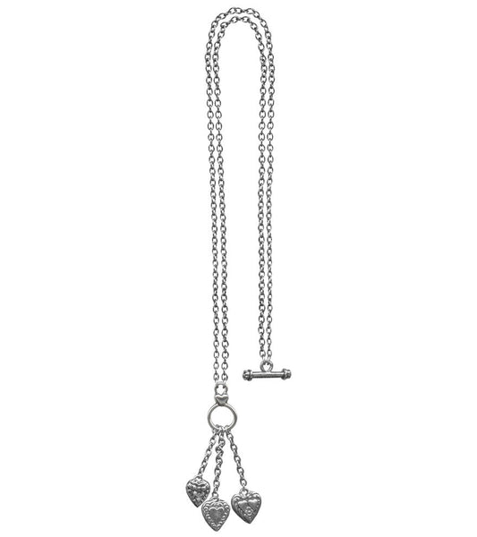 silver metal link chain toggle necklace with trio of heart charms hanging from three smaller chains at front of necklace. Chain shown in single layer for 36" necklace