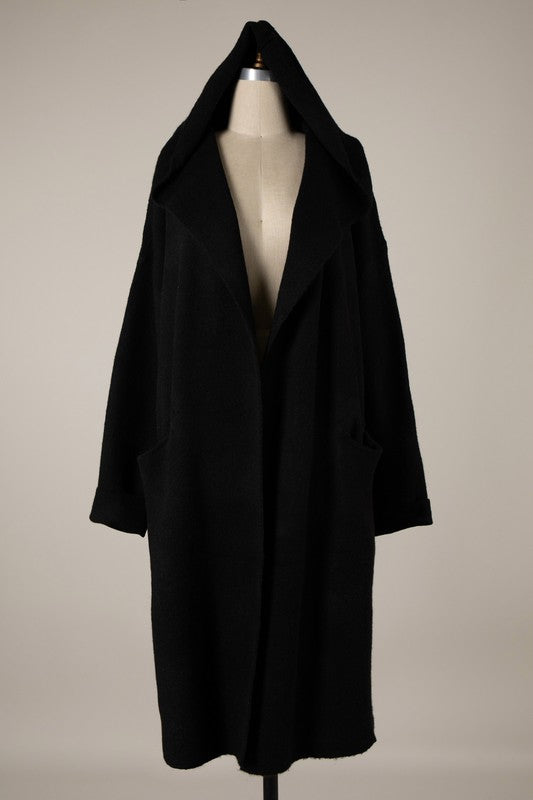 Black medium weight long open cardigan style sweater with dropped shoulders, a hood, and inset front pockets. Shown on a dress form in a full length shot