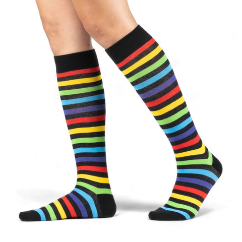 black and rainbow stripe unisex knee socks with black cuffs/heels/toes. Shown worn from the side