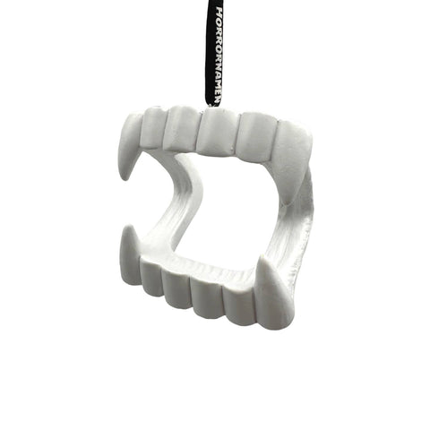 resin painted ornament in the shape of white plastic vampire fangs opened