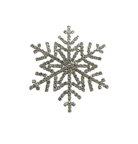 Decorative snowflake brooch with clear rhinestones on a white background