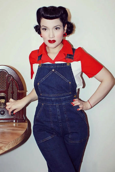 model wearing button-up shirt underneath dark wash 1950s style reproduction denim overalls