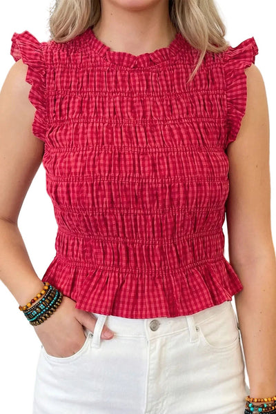 Slightly cropped shirred elastic sleeveless top in pink and red gingham print with ruffled arm openings, bottom hem, and neckline