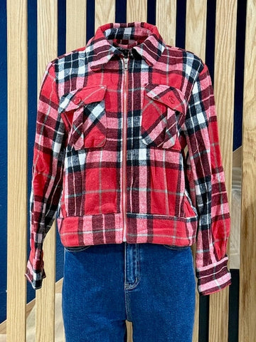 Red, black, and white plaid faux wool jacket in a 1950s silhouette with chest pockets and metal front zip. Shown on dress form with blue denim jeans
