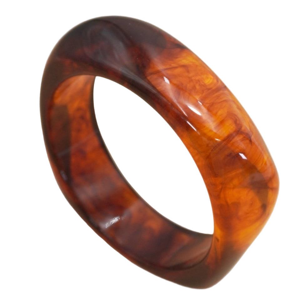 rounded square resin bangle in translucent amber with darker brown marbling